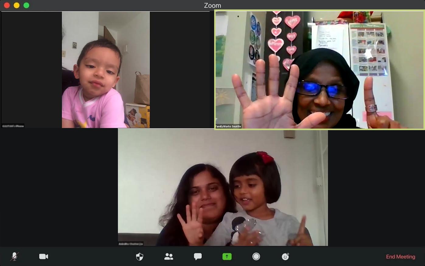 A Zoom video chat window showing three participants of a virtual playgroup doing a counting activity.