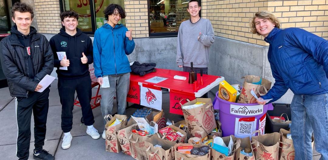 High school students from the Lincoln High School Boys Soccer Team pose for a photo outside of a local grocery store during a food drive.